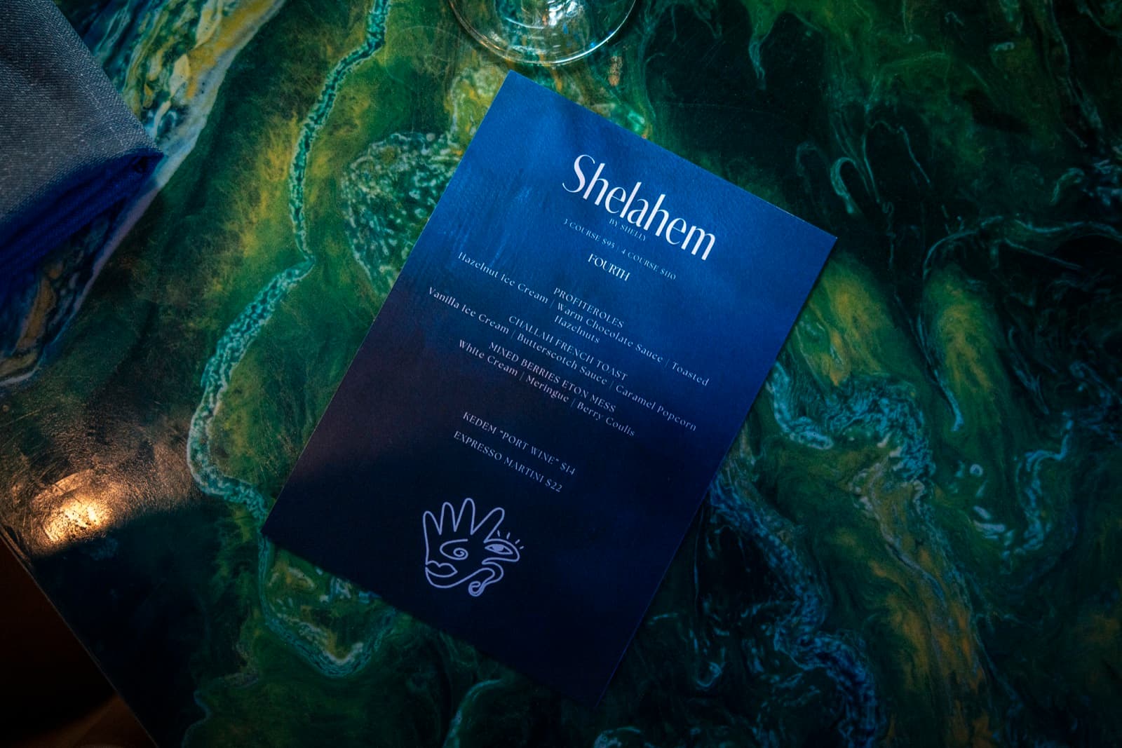 Shelahem by Shelly menu on the marbled tabletop