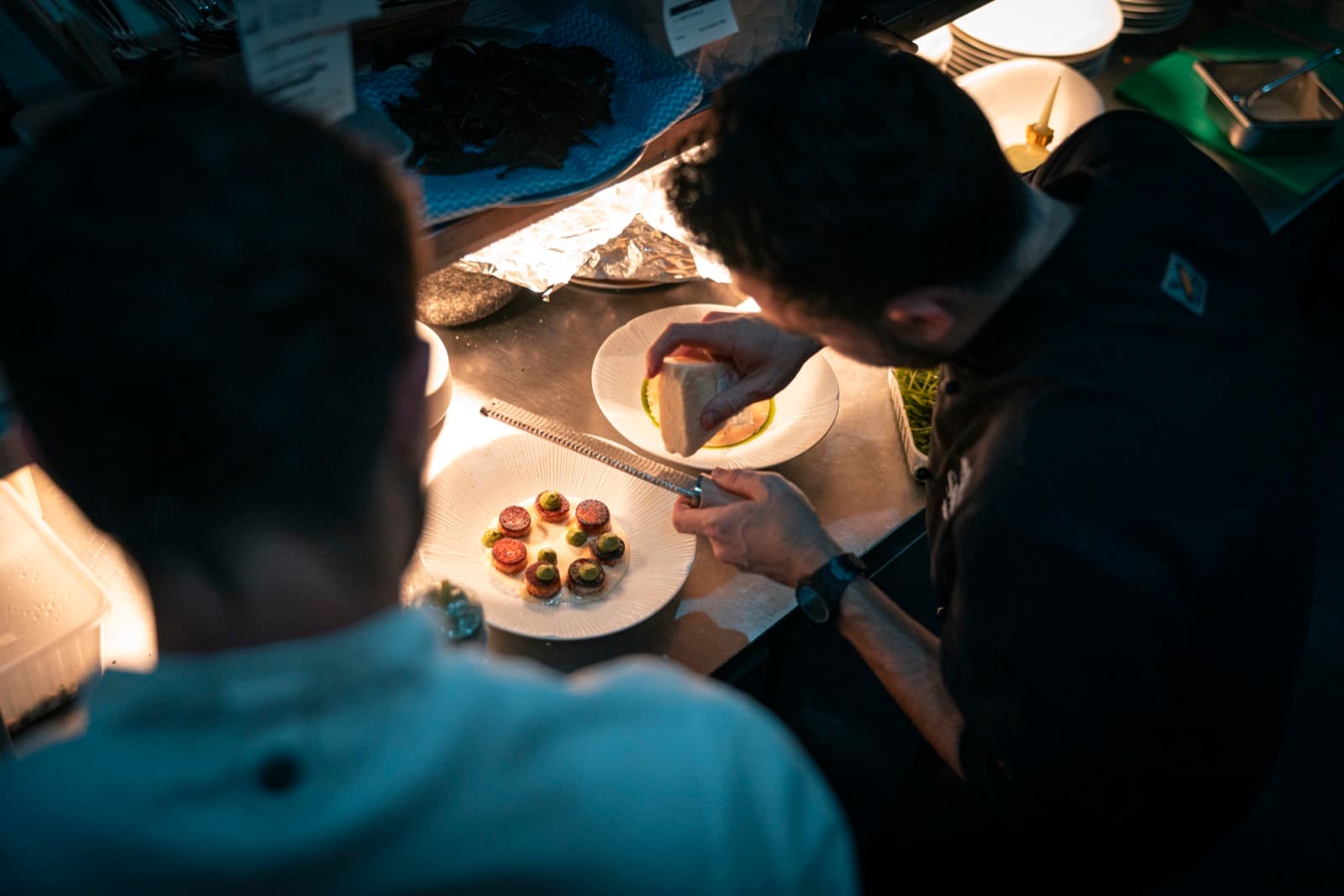 Two chefs plating a duo of Shelly courses